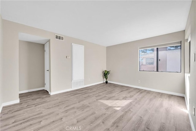 spare room with light hardwood / wood-style flooring