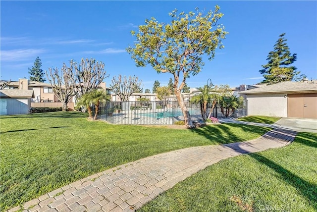 view of yard with a fenced in pool and a patio area