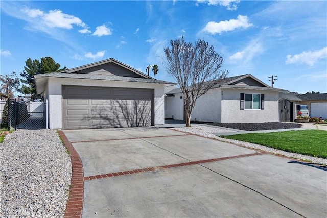 ranch-style house featuring driveway, fence, an attached garage, and stucco siding