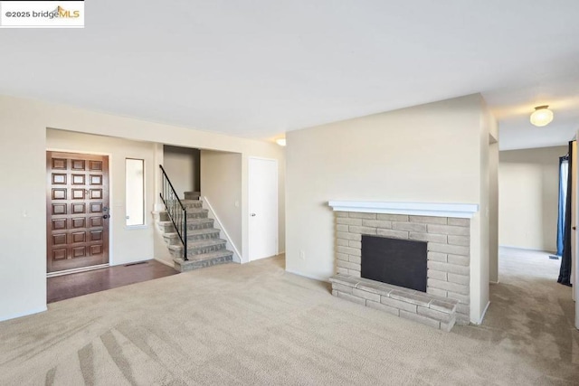 unfurnished living room featuring a fireplace and light carpet