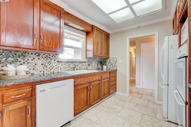 kitchen with stone countertops, sink, decorative backsplash, ornamental molding, and white appliances