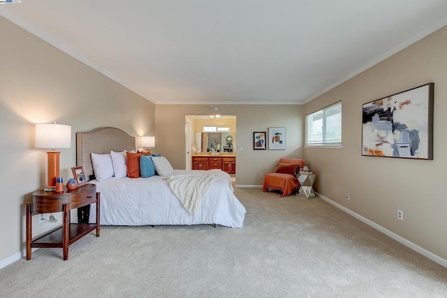 bedroom with light colored carpet, ornamental molding, and connected bathroom