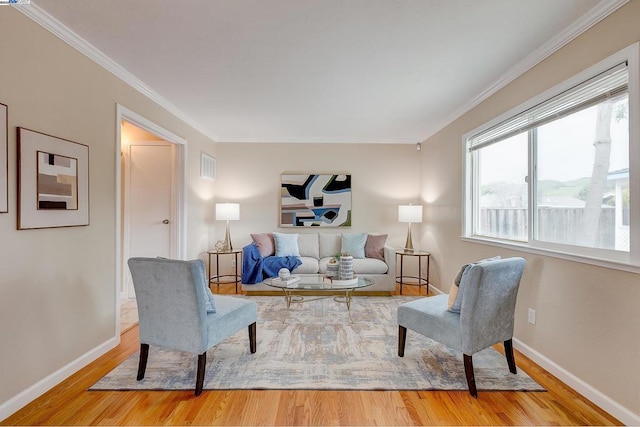 living room featuring hardwood / wood-style flooring and ornamental molding