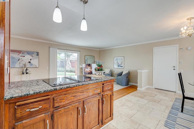 kitchen with an inviting chandelier, crown molding, pendant lighting, and black electric cooktop