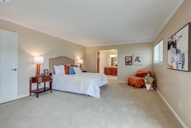 bedroom with crown molding, connected bathroom, and light colored carpet