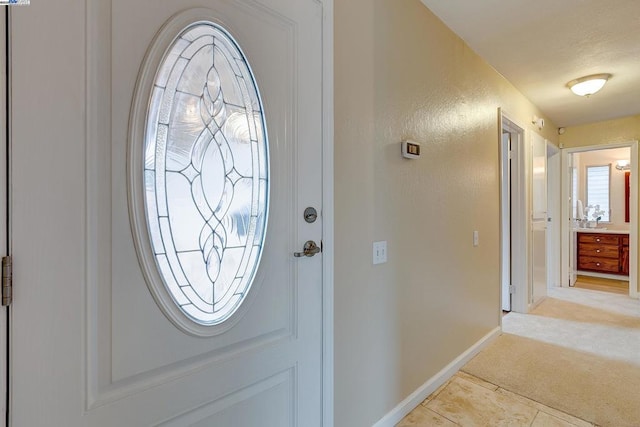 entrance foyer featuring light carpet