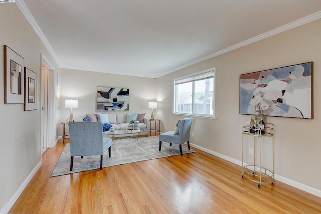 living room with ornamental molding and hardwood / wood-style floors