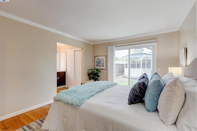 bedroom featuring ornamental molding, light hardwood / wood-style floors, and access to outside