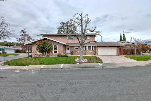 view of front of home featuring a garage and a front yard