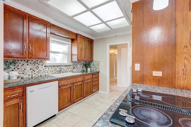 kitchen featuring sink, white dishwasher, stone counters, black electric stovetop, and backsplash