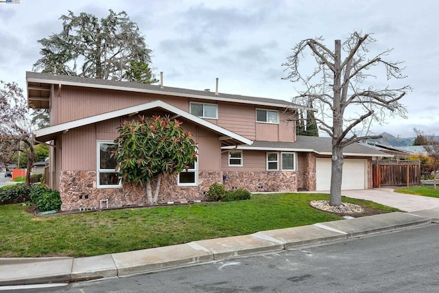 view of front of home with a garage and a front lawn