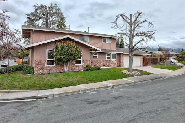 view of front of house with a garage and a front lawn