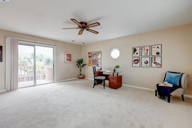 sitting room featuring light colored carpet and ceiling fan