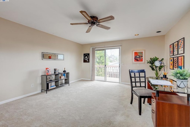 carpeted office space with ceiling fan