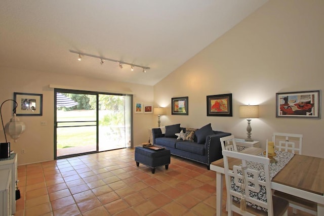 tiled living room featuring high vaulted ceiling and rail lighting