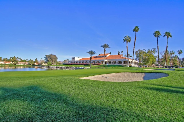 view of home's community featuring a water view and a lawn