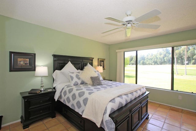 tiled bedroom with access to exterior and ceiling fan