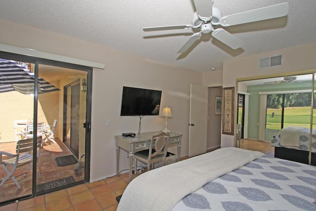 bedroom with ceiling fan, access to outside, a textured ceiling, and light tile patterned floors