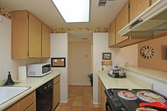 kitchen with sink, light tile patterned floors, built in desk, and black appliances