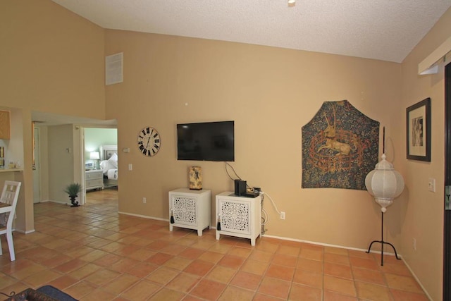 living room featuring lofted ceiling and light tile patterned floors