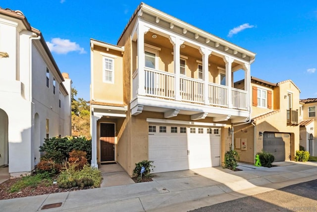 townhome / multi-family property with a balcony and a garage