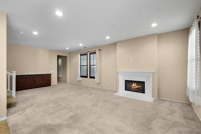 unfurnished living room featuring light colored carpet