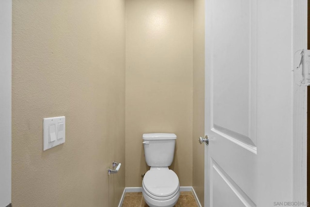 bathroom with tile patterned flooring and toilet