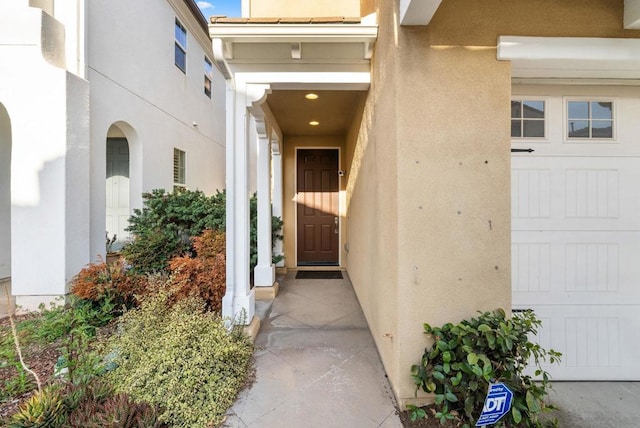 view of exterior entry featuring a garage