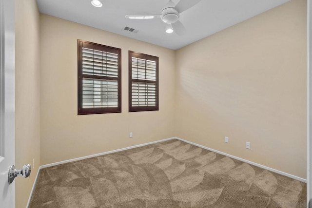 unfurnished room with ceiling fan and carpet