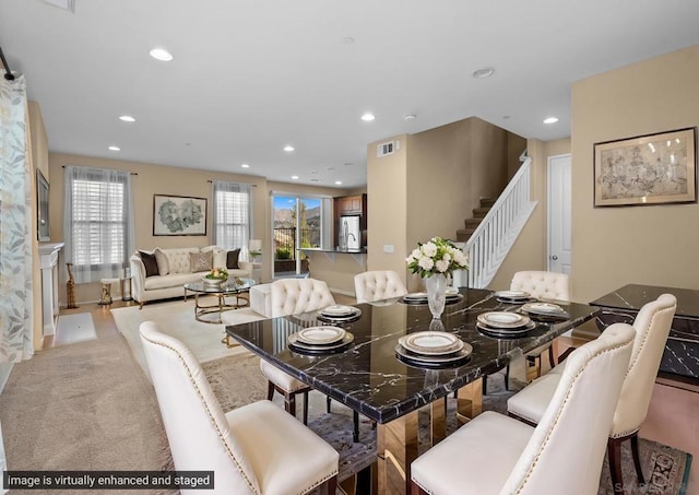 dining area featuring light carpet