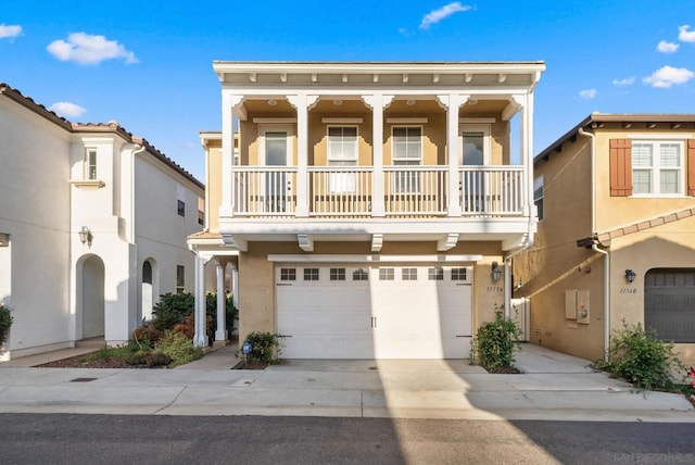 view of front of property featuring a garage and a balcony