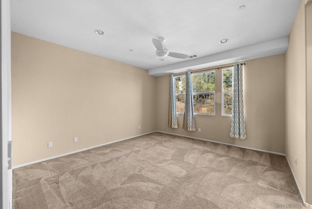 unfurnished room featuring light carpet and ceiling fan