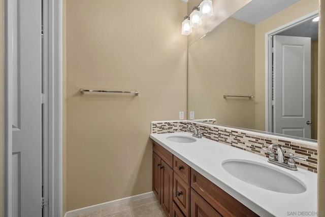 bathroom with tasteful backsplash, vanity, and tile patterned flooring