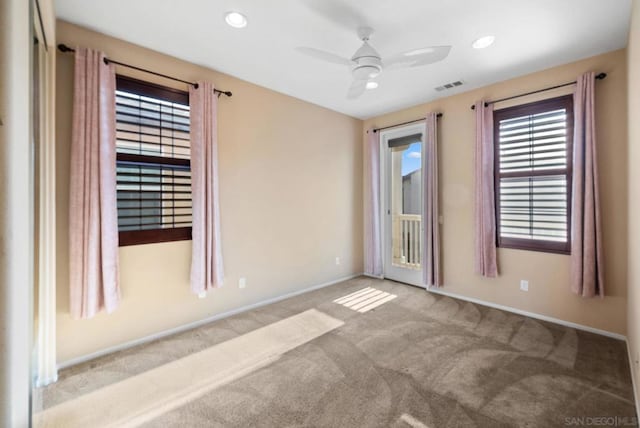 empty room with light colored carpet and ceiling fan