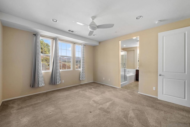 carpeted spare room with ceiling fan