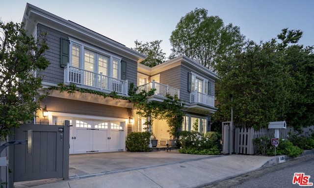 view of front of house featuring a balcony and a garage