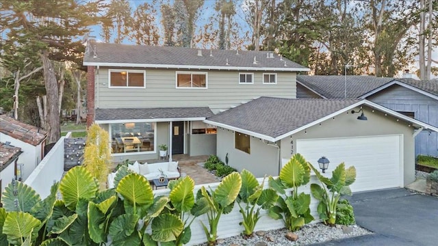 view of front of home with a garage and an outdoor living space