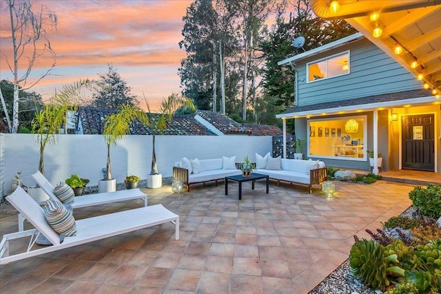 patio terrace at dusk featuring outdoor lounge area