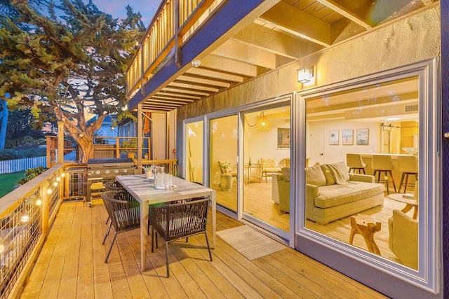 deck at dusk with an outdoor hangout area