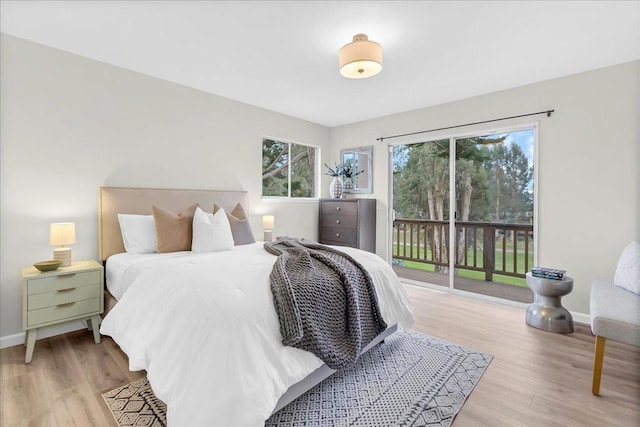 bedroom with access to exterior and light hardwood / wood-style flooring