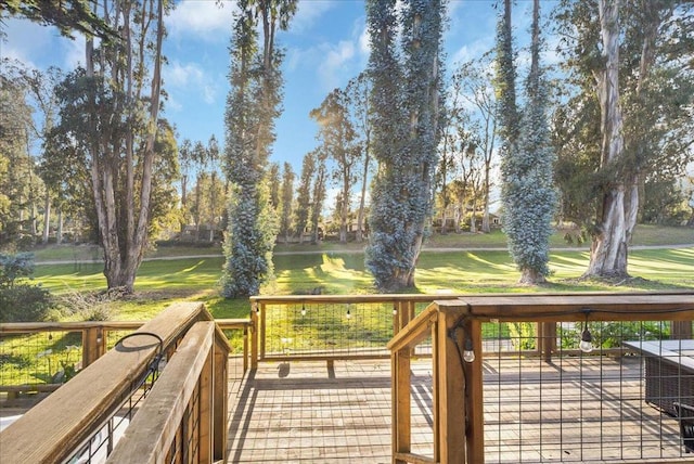 deck featuring a water view and a lawn