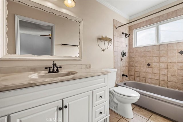 full bathroom featuring tiled shower / bath combo, ornamental molding, vanity, toilet, and tile patterned floors