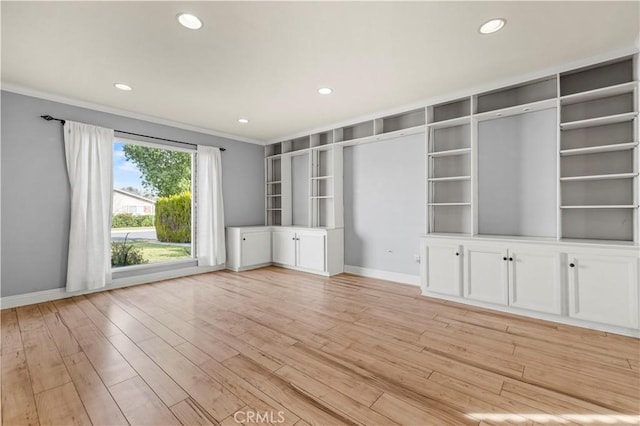 unfurnished living room with light hardwood / wood-style flooring and ornamental molding