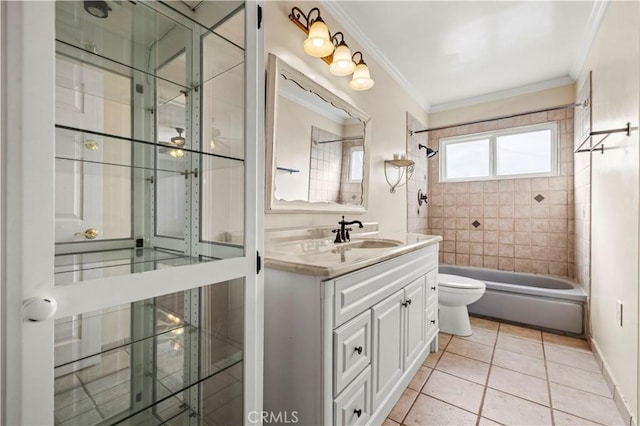 full bathroom with tile patterned flooring, tiled shower / bath combo, vanity, toilet, and crown molding