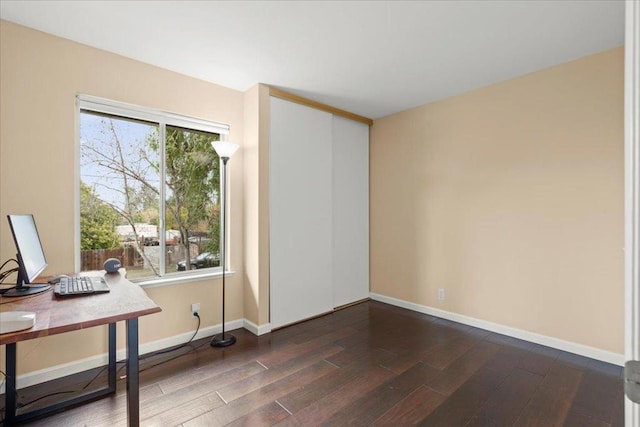 home office with dark hardwood / wood-style floors