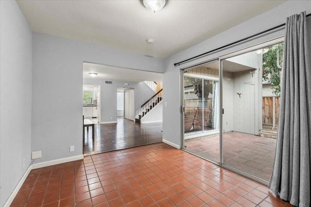 unfurnished room featuring tile patterned floors and a healthy amount of sunlight