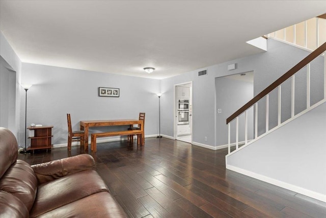 living room with dark hardwood / wood-style floors