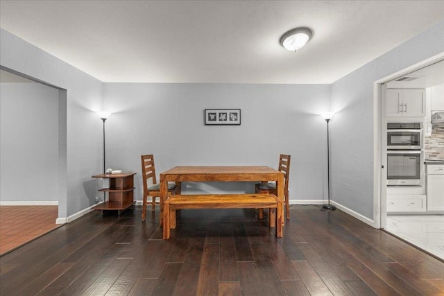 dining room with dark hardwood / wood-style floors