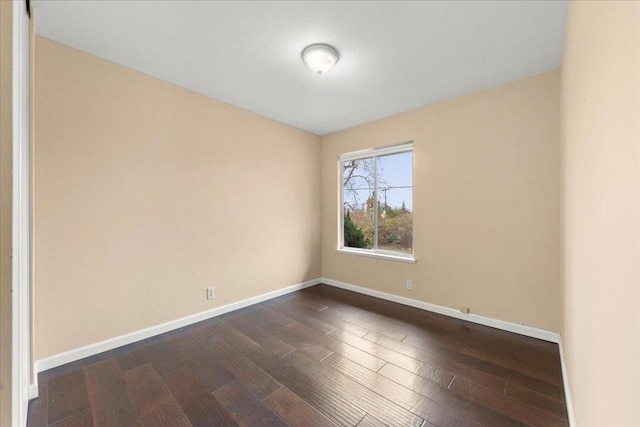 spare room with dark hardwood / wood-style flooring