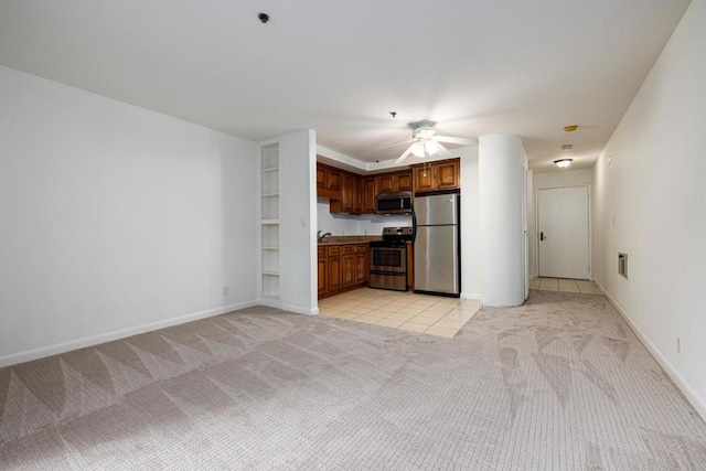 kitchen featuring appliances with stainless steel finishes, light carpet, and ceiling fan